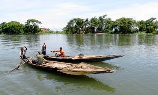 fishermen on wooden boats on the lake