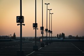 signs on the parking lot against the evening sky
