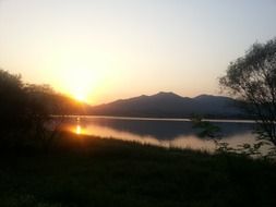 distant view of the sunset behind the mountains