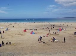A lot of people on the sandy beach in Cornwall