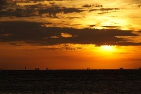 sun behind a cloud at sunset in copenhagen