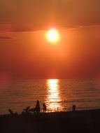 couple walking on the beach at the sunset