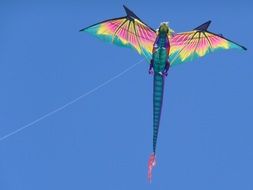 colorful dragon kite flying in a clear blue sky