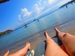 female legs on beach at sea, turkey, bodrum