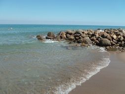 calm clear sea at rocky coast, italy, sicily