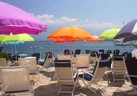 chaise lounges and colorful umbrellas on the beach