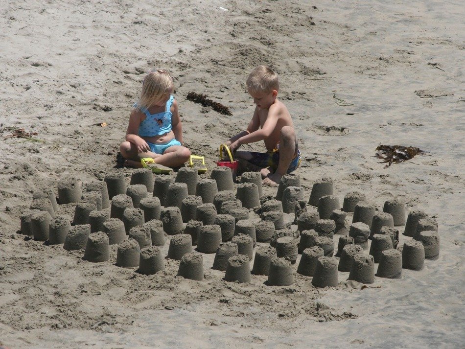 children to stick a tower out of sand on the beach