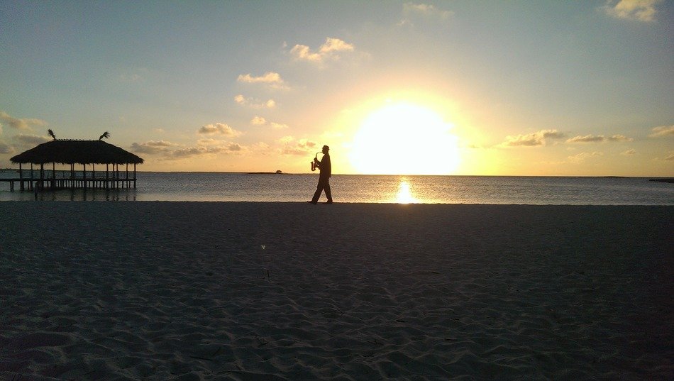 saxophonist on the beach at sunset in cuba