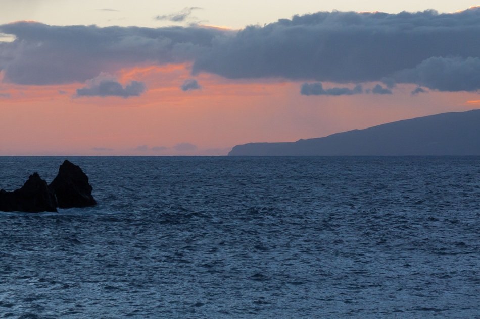 romantic sunset over a cliff in the sea