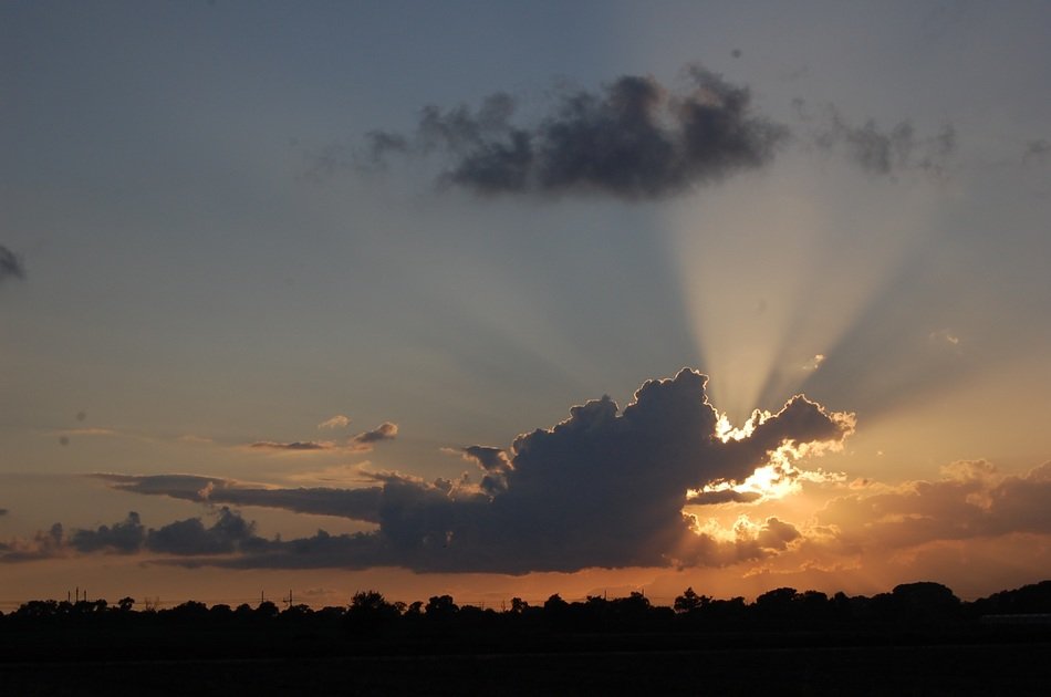 the sun behind the cloud at dusk