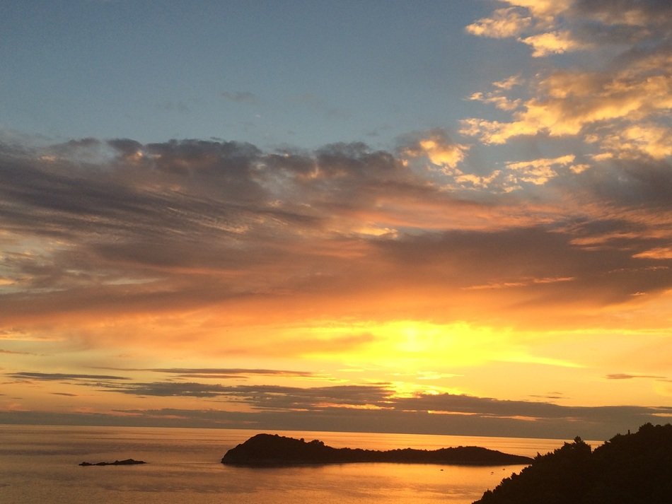 silhouettes of Islands in the sunset