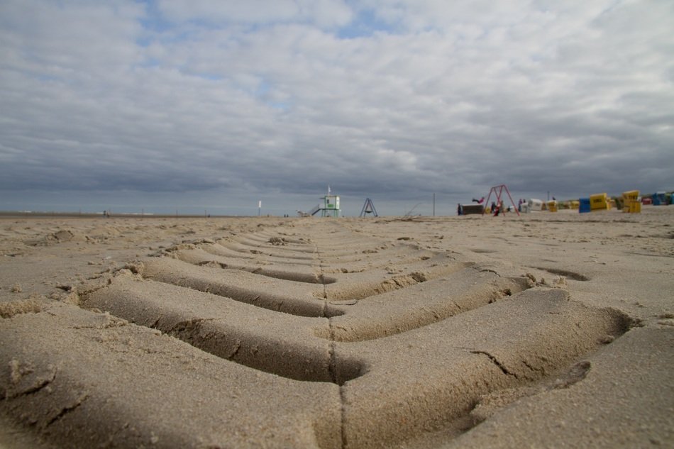 tire track on sand beach of north sea