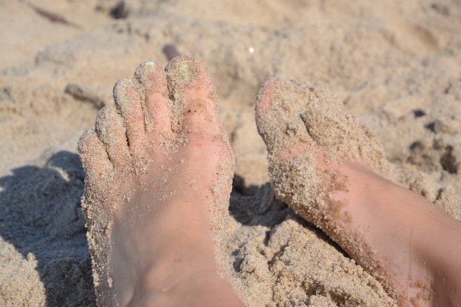 sand on wet female legs