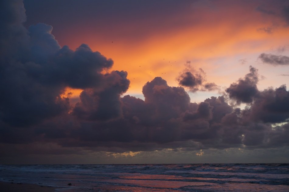 storm clouds over the ocean coast at sunset