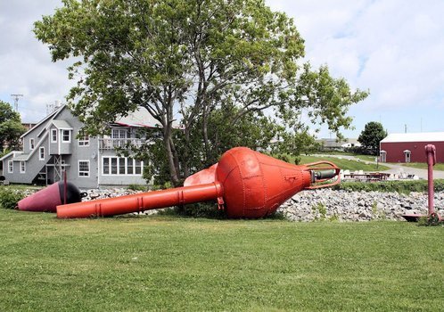 red buoys on the lawn in front of house