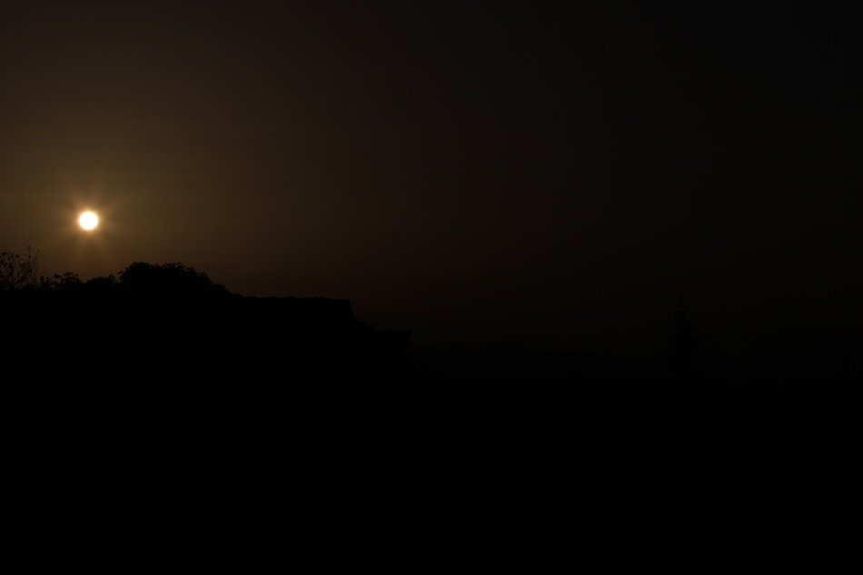 setting sun in the black sky