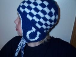 a boy in a blue and white hat with a horseshoe pattern