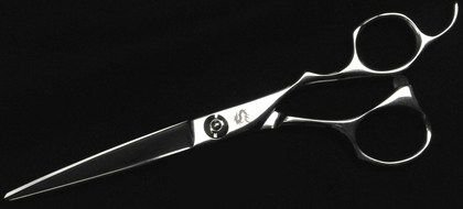 metal scissors for haircuts on a black background