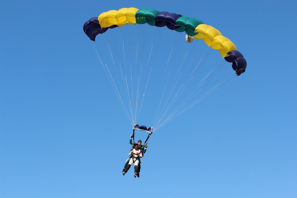 Jump with a striped parachute free image download