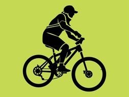 Silhouette of man riding bicycle at green background