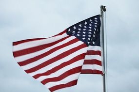 American flag in the wind on a cloudy day
