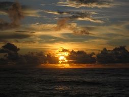 orange cloudy sunset above sea, usa, hawaii