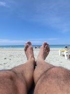 relaxing legs on the beach