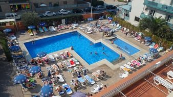 people near blue water pool