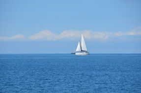 sailboat on the blue sea surface