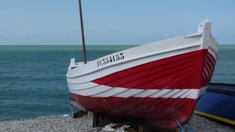 white fishing boat on the shore