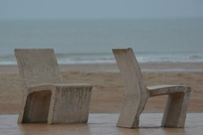 stone chairs on the beach