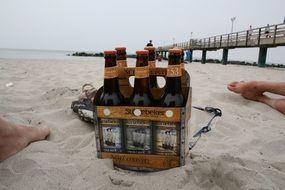 beer bottles in a box on the beach