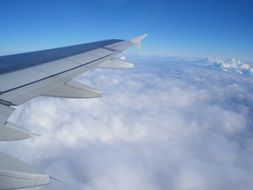 the wing of the aircraft above the thick clouds