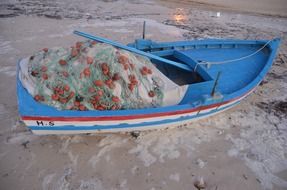 blue boat with fishing nets