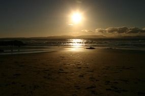 Surf on the beach at sunset
