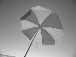 retro parasol on the beach in black and white image