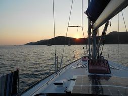 sailboat in the Mediterranean Sea on sunset background