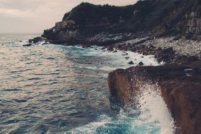 waves splashing on rocky coast, portugal
