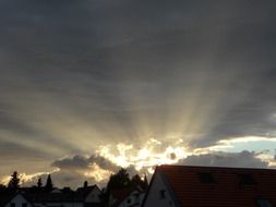 sunset rays under dark clouds