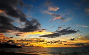 sunset in the clouds over the ocean beach