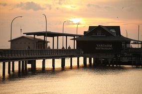 pier on ocean romantic sunset scene