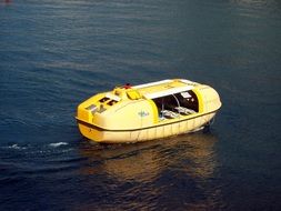 yellow life boat on water