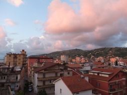 pink sunset over a city in italy