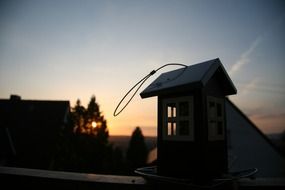 silhouette of bird feeders at sunset