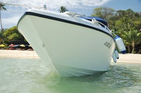 white yacht on a clean beach