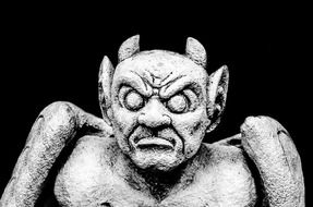 devil, aged stone sculpture