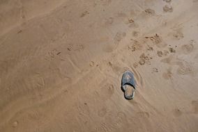 forgotten shoes in the sand on the beach