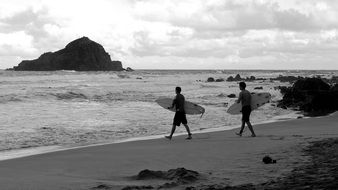 two surfers on the beach in Hawaii