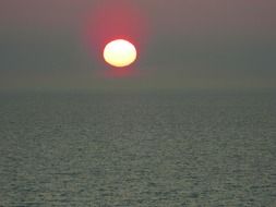bright evening sun over the water on the horizon