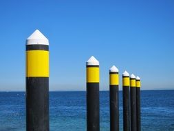 ocean yellow posts near water